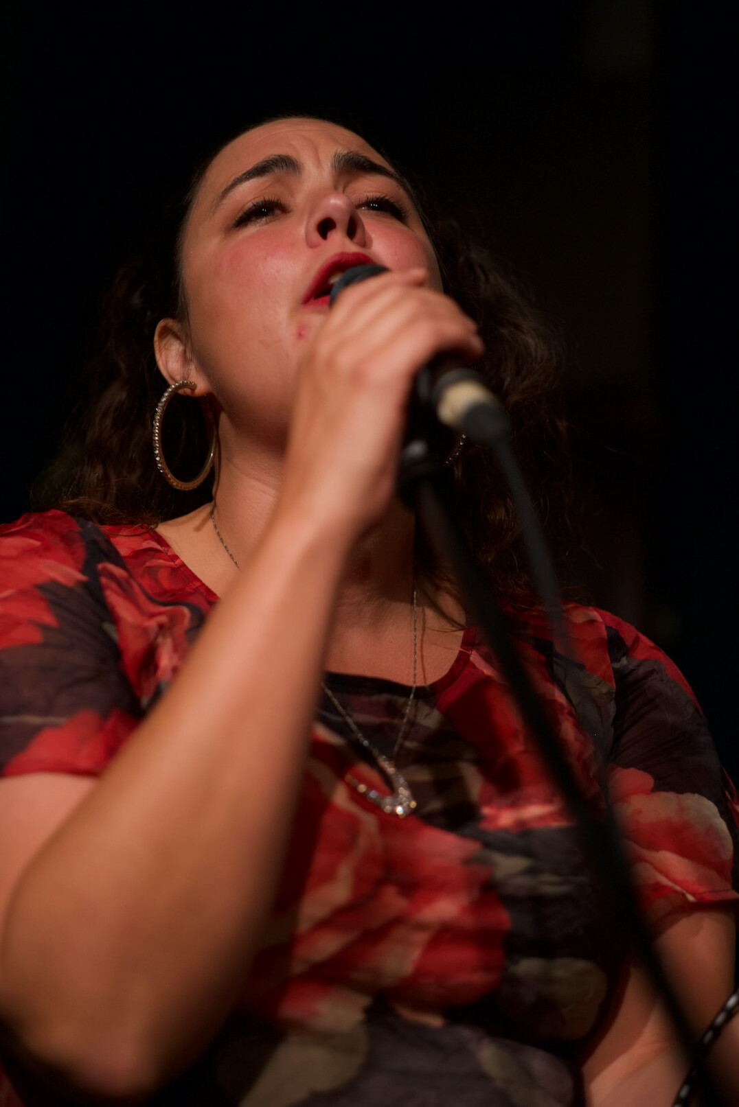 Portrait of a Latina singer with microphone