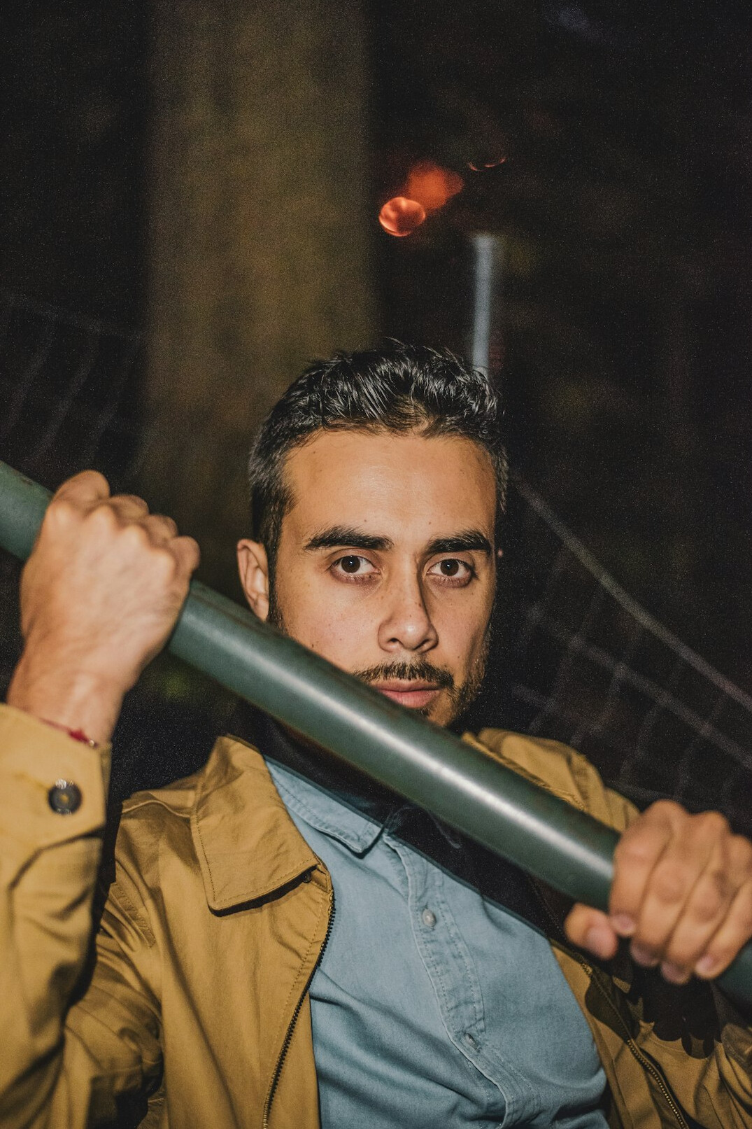 Portrait of a Latino photographer holding a camera