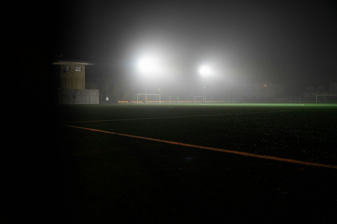 Football stadium at night with bright floodlights