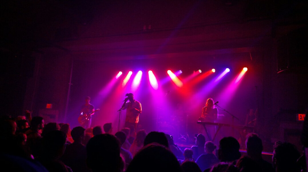 Concert stage with colorful lights and crowd